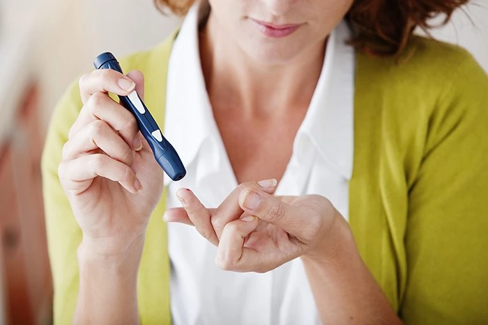Diabetes - A woman test her insulin levels